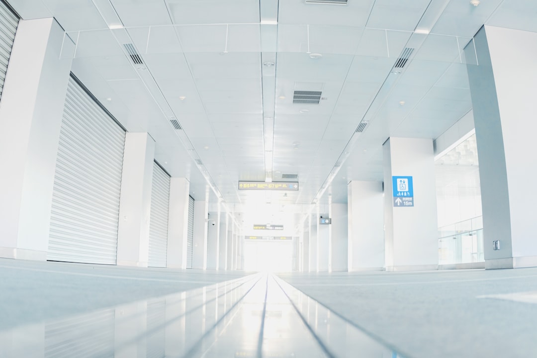 a-long-hallway-with-white-walls-jrluy1shrk4