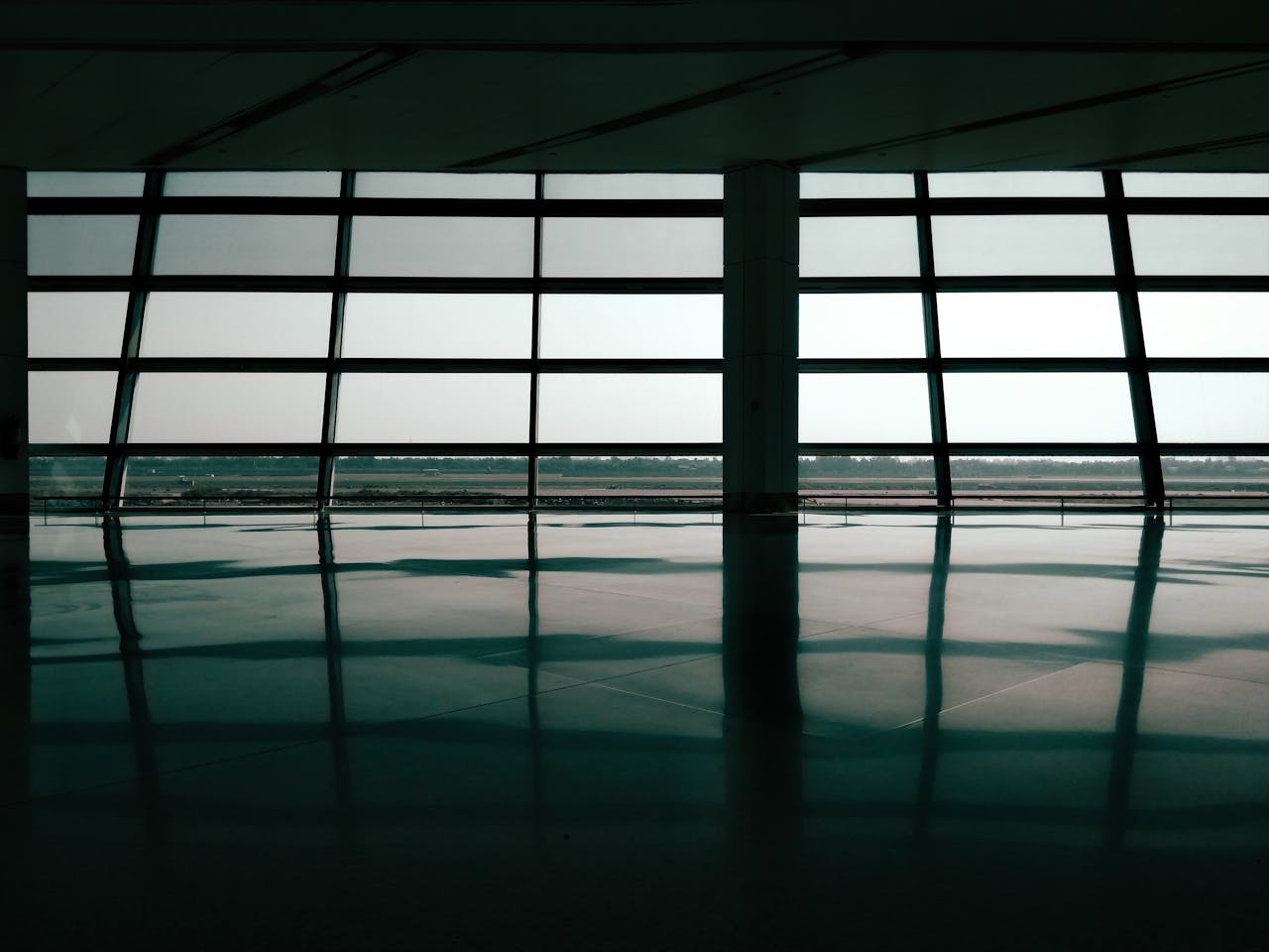 Spacious airport terminal window reflections create a geometric and architectural effect.
